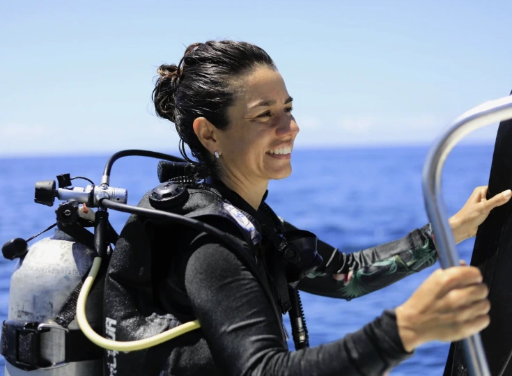 PADI instructor teaching open water diving skills to student in tropical ocean, Santa Teresa